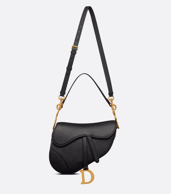 Black handbag with gold accents on a light gray background