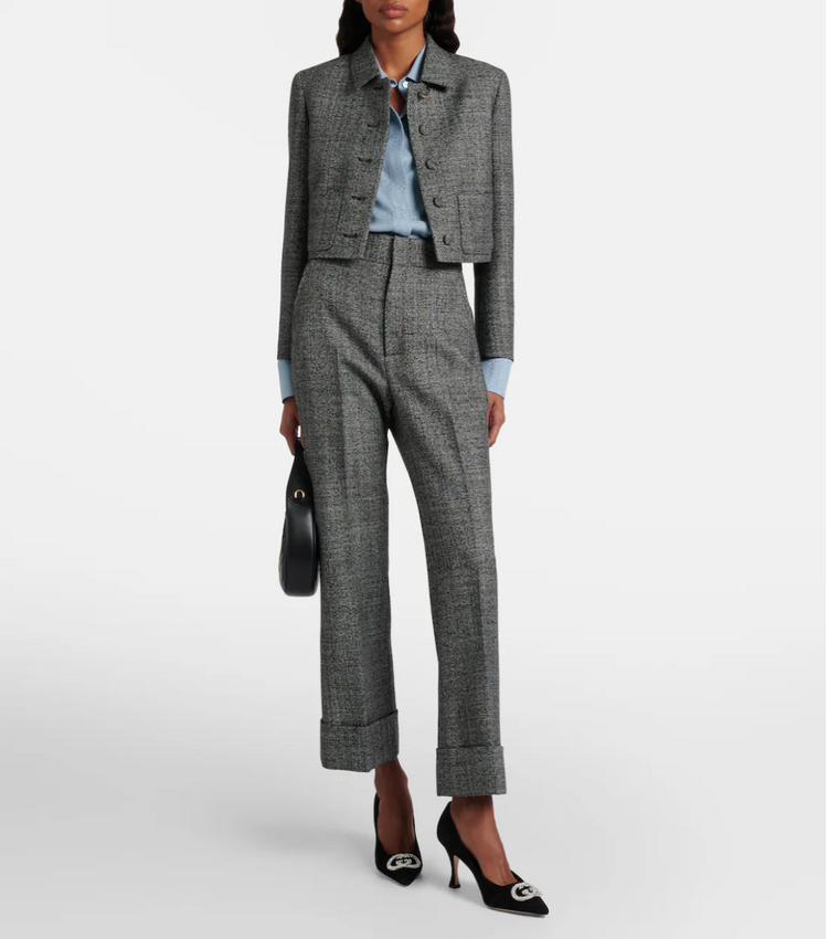 Woman wearing a gray suit with a white background