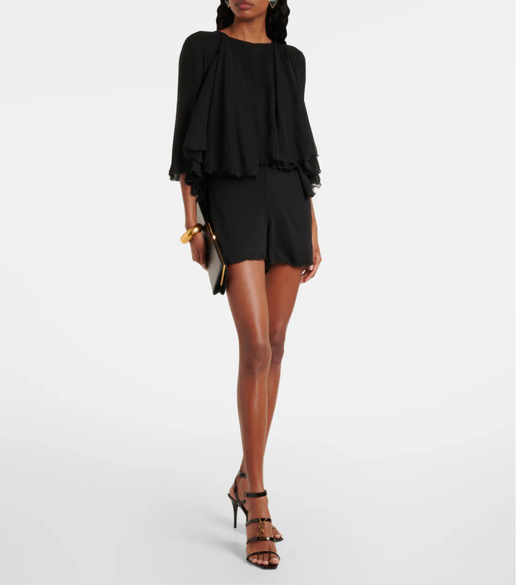 Woman wearing a black outfit with a white background