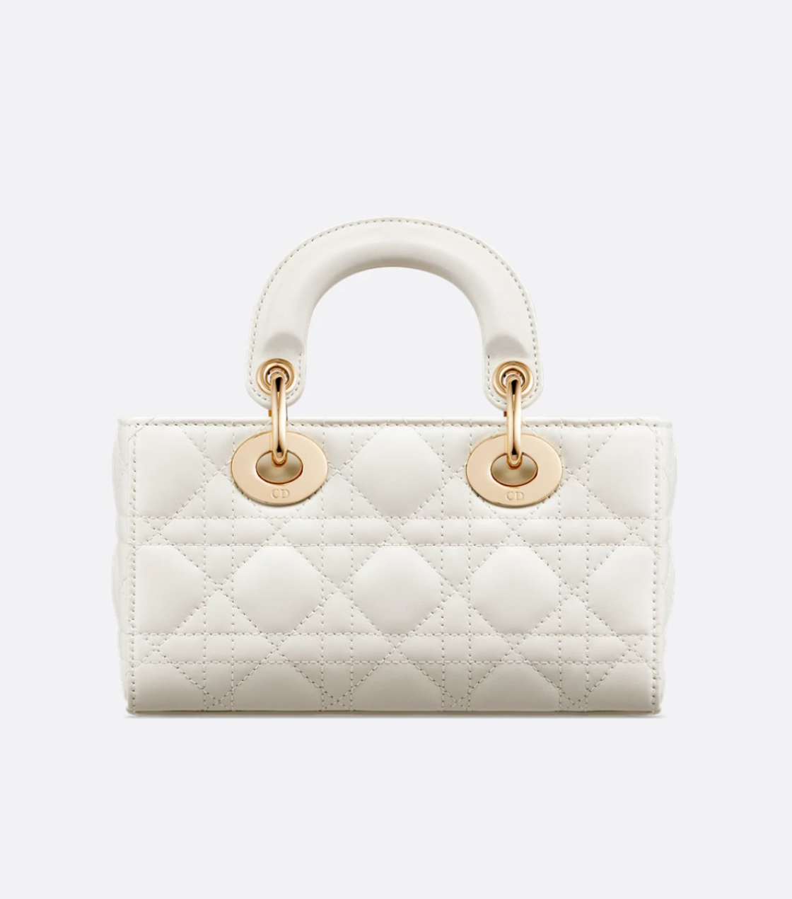White quilted handbag with gold hardware on a light gray background