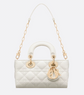 White quilted handbag with gold chain strap and hardware on a white background