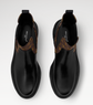 Black leather boots with brown accents on a white background