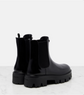 Black rubber boots with chunky sole on a light gray background
