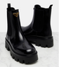 Black Prada boots on a light gray background