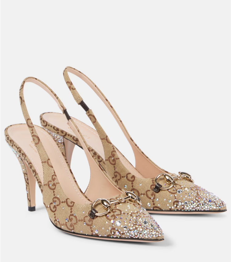 Beige high-heeled shoes with embellishments on a white background