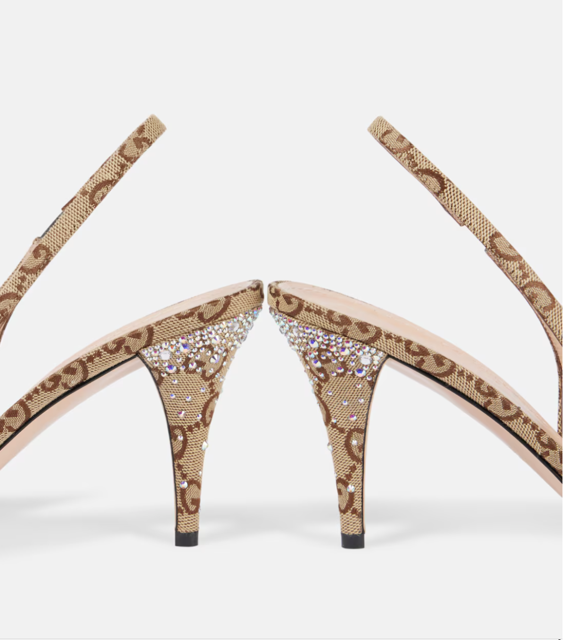 High-heeled shoes with decorative straps and embellishments on a white background