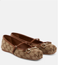Pair of brown and beige patterned shoes with decorative straps on a white background