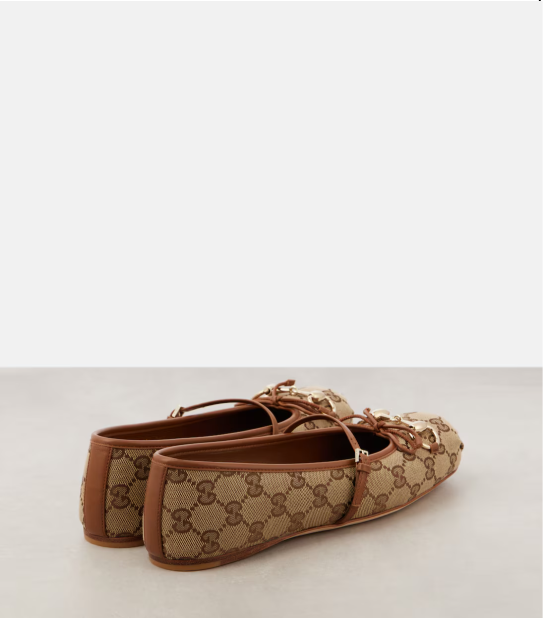 Pair of brown and beige loafers on a light gray background