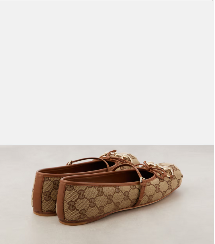 Pair of brown and beige loafers on a light gray background