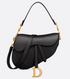 Black handbag with gold accents on a light gray background