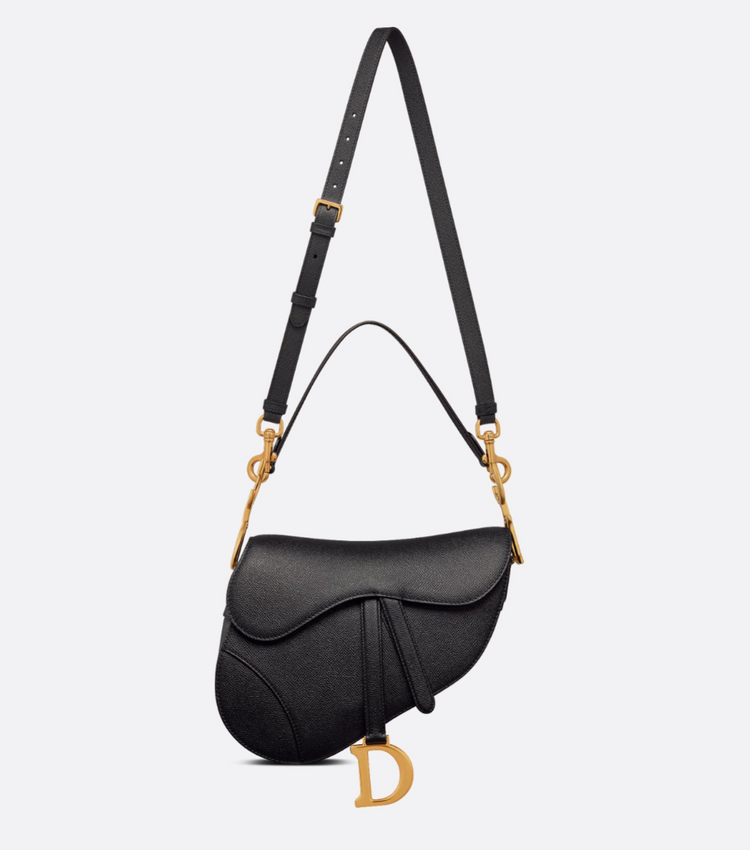 Black handbag with gold accents on a light gray background