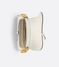 White handbag with gold accents on a light gray background
