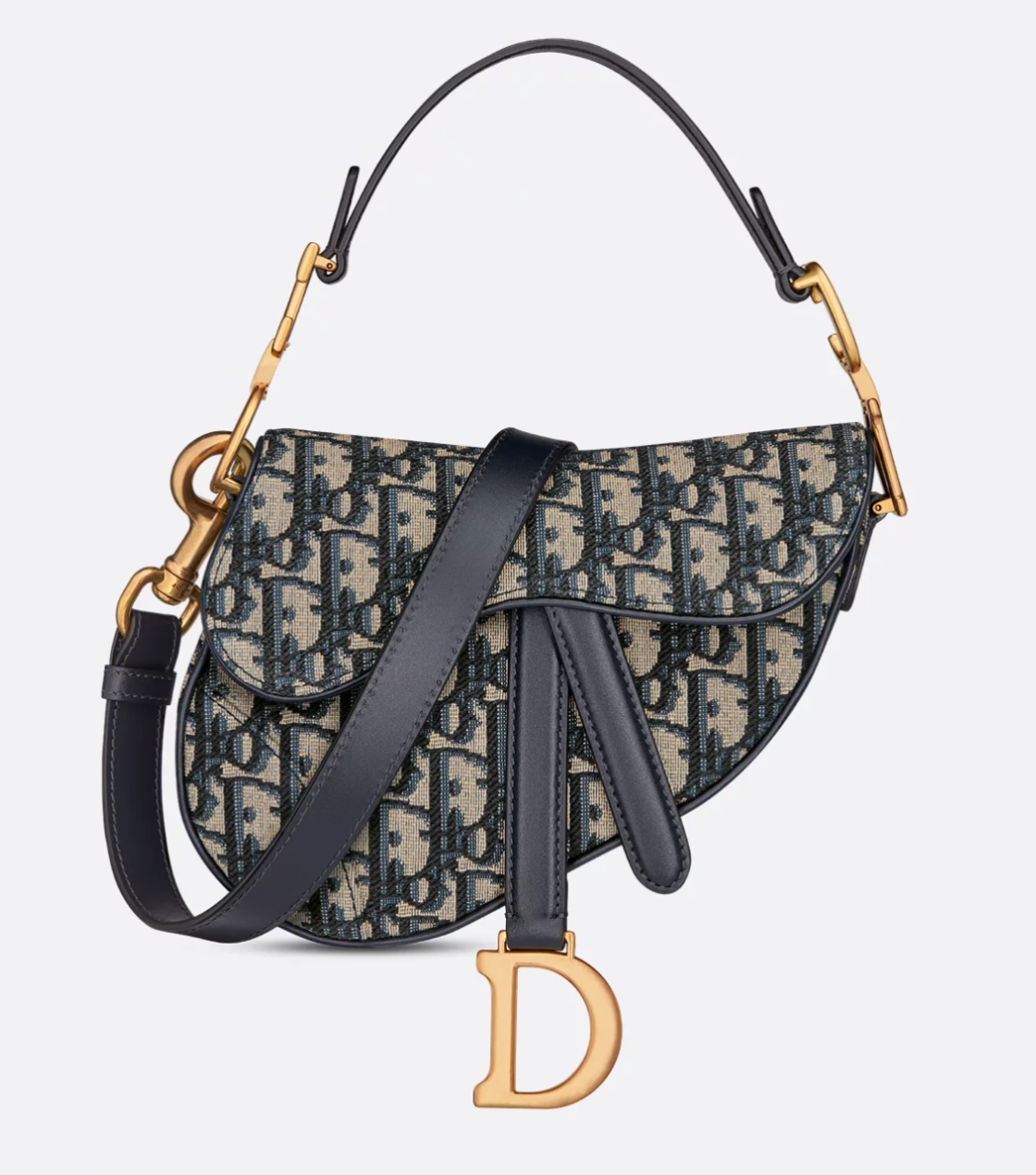 Christian Dior handbag with patterned fabric and gold accents on a light gray background