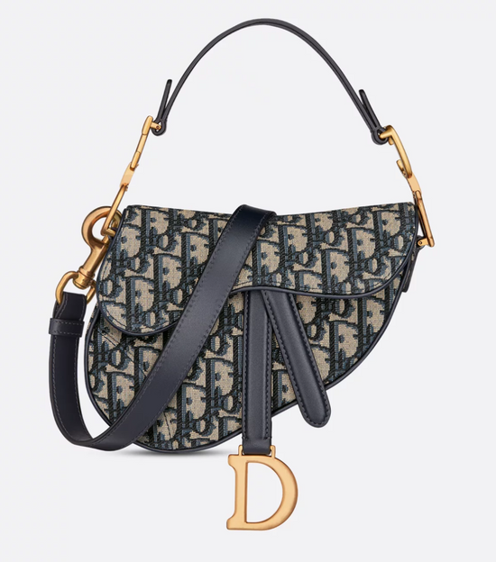Christian Dior handbag with patterned fabric and gold accents on a light gray background
