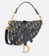 Christian Dior handbag with patterned fabric and gold accents on a light gray background