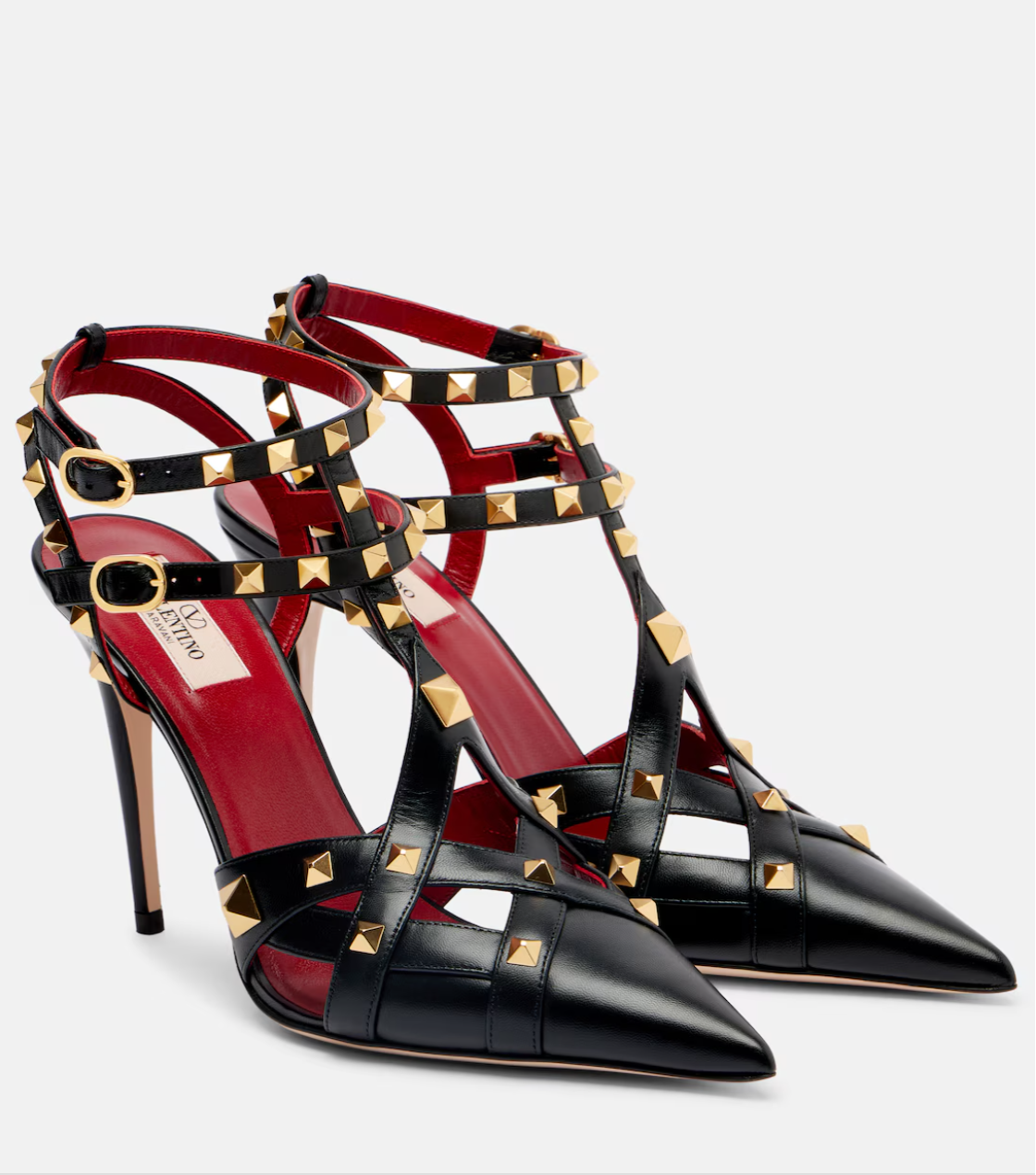 Black high-heeled sandals with gold studs on a white background