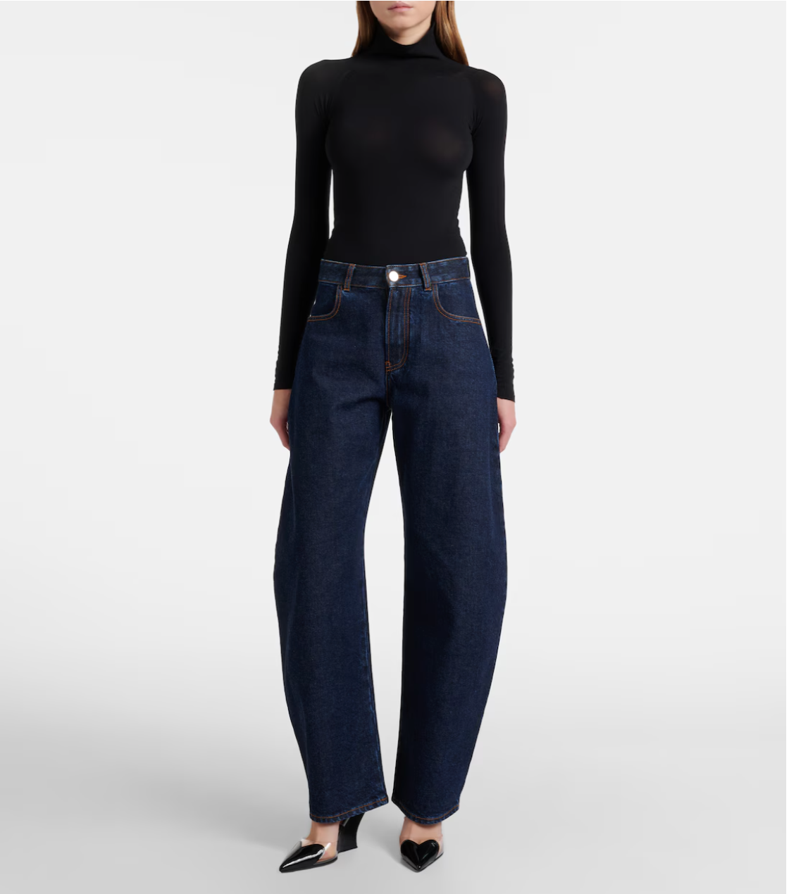 Person wearing dark blue jeans and a black turtleneck on a white background