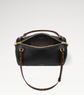 Black handbag with gold accents on a light gray background