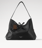 Black handbag with a visible brand tag on a light gray background