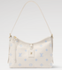 Beige handbag with blue monogram pattern on a light gray background