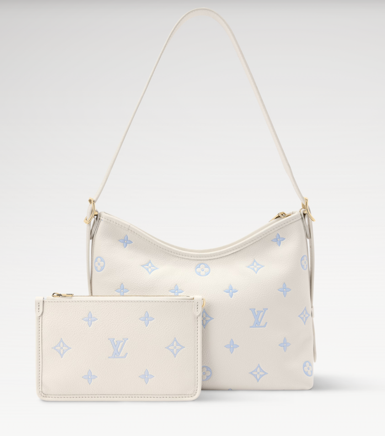White Louis Vuitton handbag with blue monogram pattern on a white background