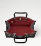 Black and red handbag with gold accents on a white background