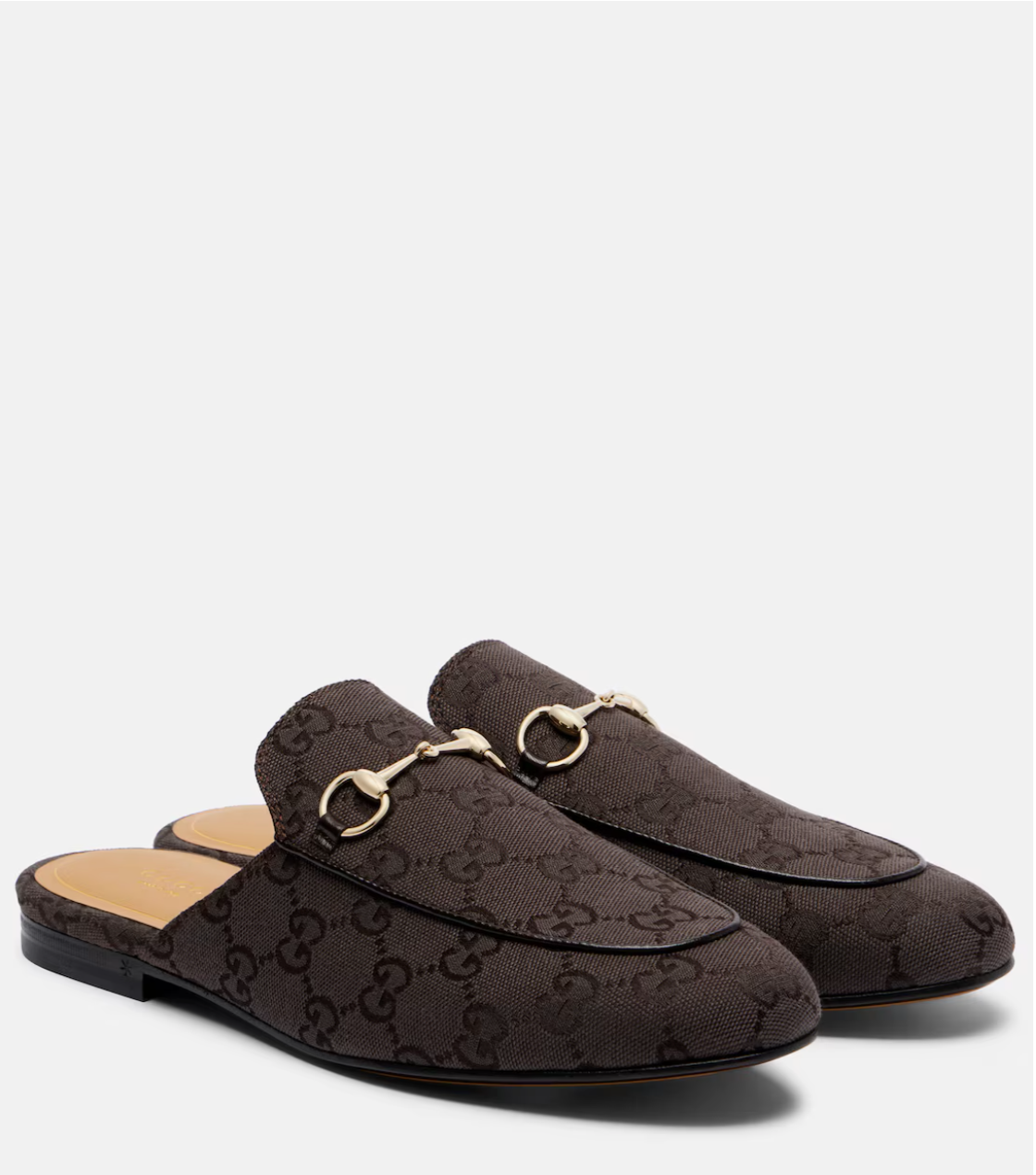 Brown patterned slippers with gold accents on a white background
