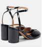 Black high-heeled shoes with strappy design on a white background
