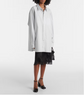 Person wearing a white shirt and black skirt on a white background