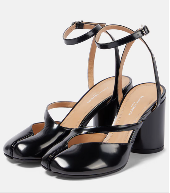 Black high-heeled shoes with thin straps on a white background