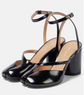 Black high-heeled shoes with thin straps on a white background