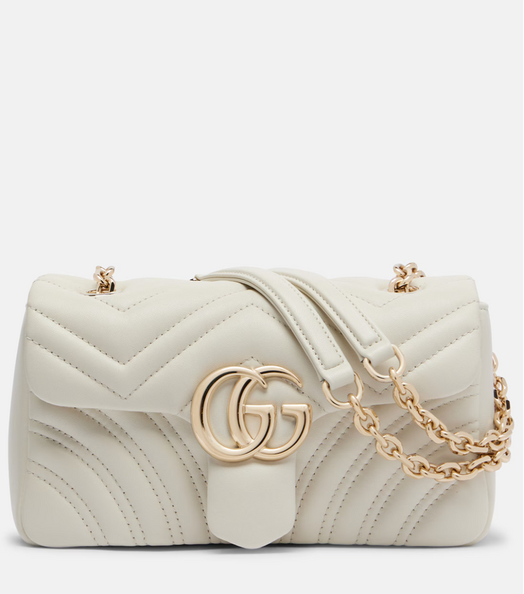 Gucci White quilted handbag with gold chain and GG logo on a white background