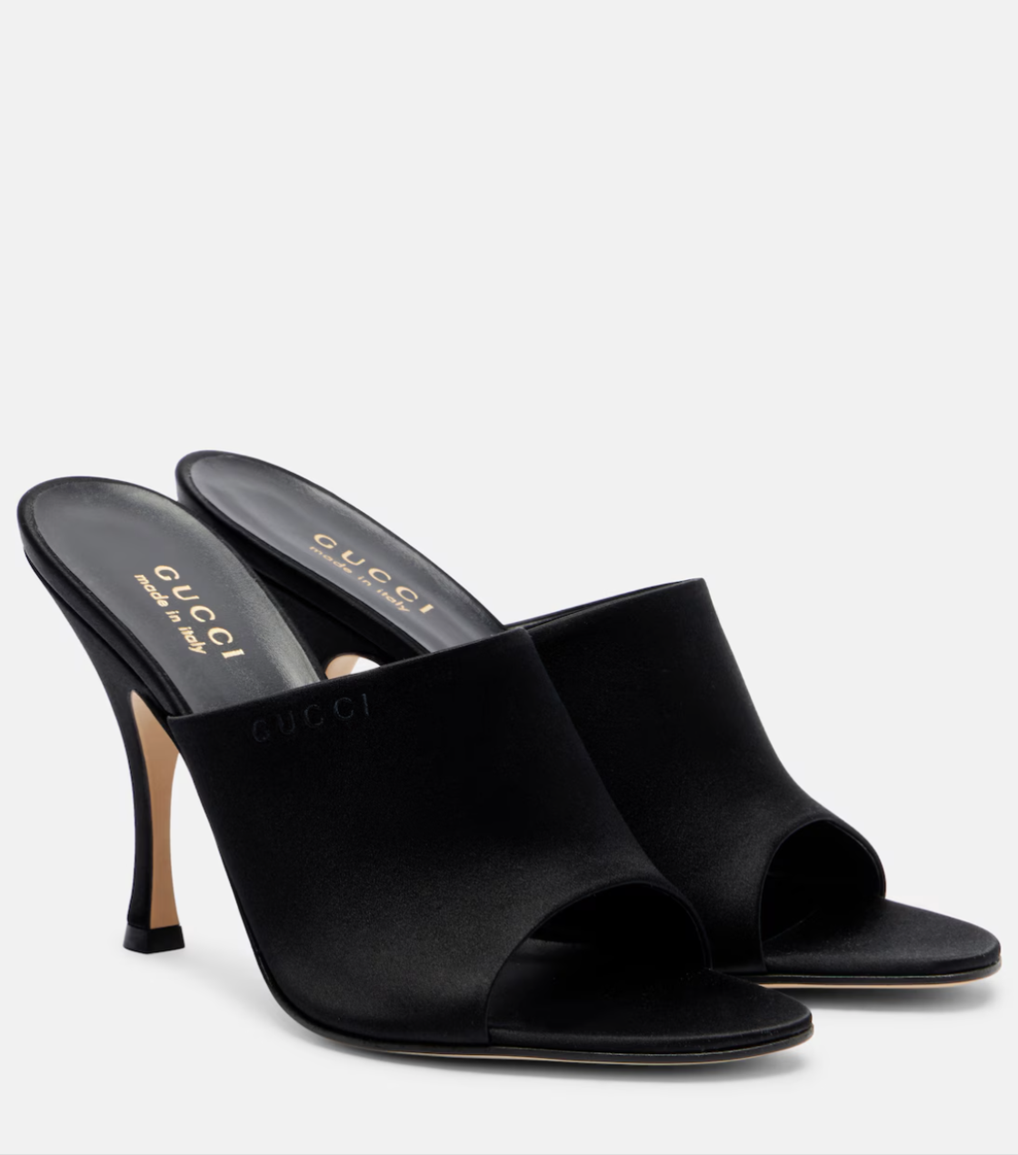 Black high-heeled mules with Gucci logo on a white background
