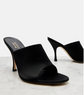 Black high-heeled mules on a light gray background