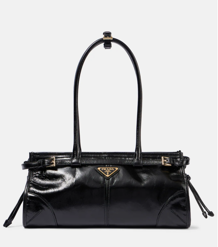 Black handbag with a brand logo on a white background