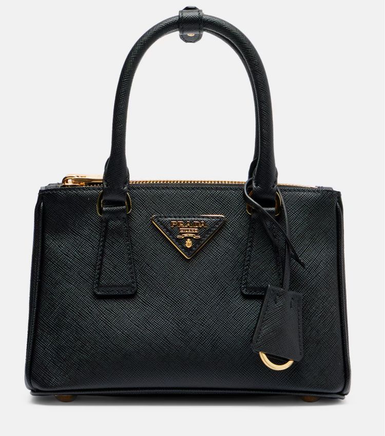Black Prada handbag with gold accents on a white background