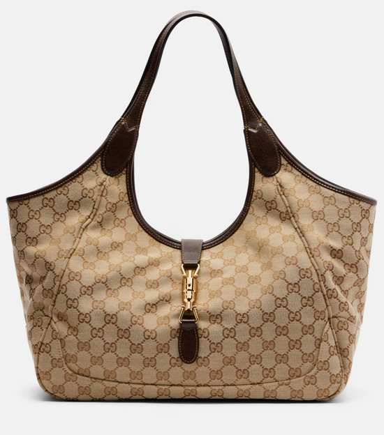 Beige gucci handbag with brown accents on a light gray background