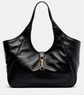 Black leather gucci handbag with gold clasp on a light gray background