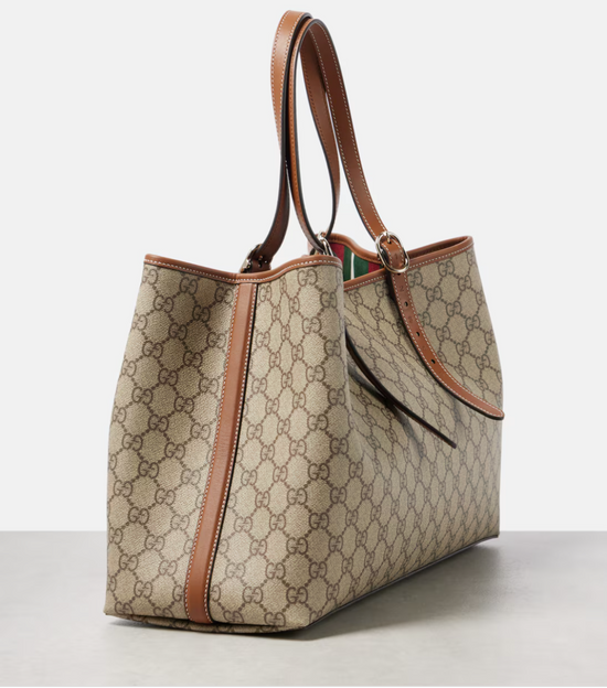 Designer gucci handbag with brown accents on a light gray background