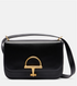 Black gucci handbag with a gold clasp on a light gray background