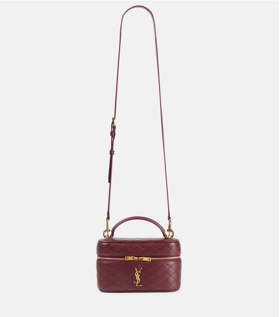 Maroon handbag with gold accents on a white background