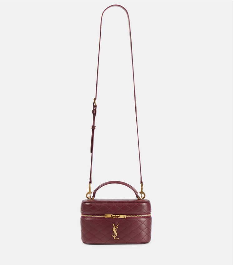 Maroon handbag with gold accents on a white background