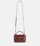 Maroon handbag with gold accents on a white background