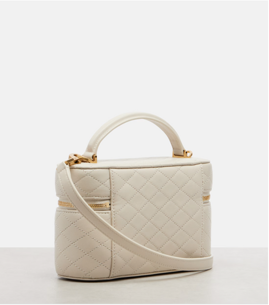 White quilted handbag with gold accents on a white background