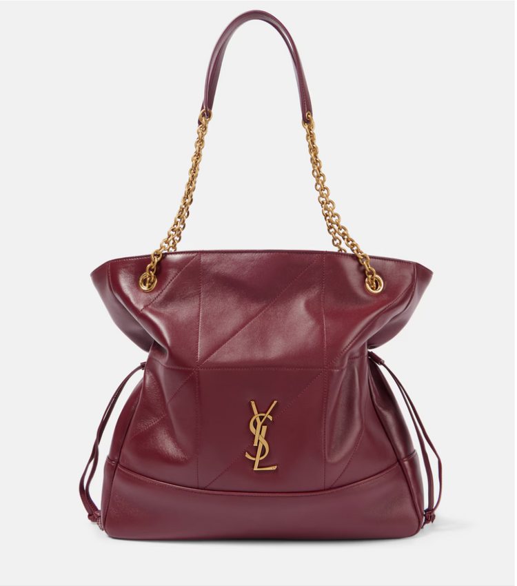 Maroon handbag with gold chain and YSL logo on a white background