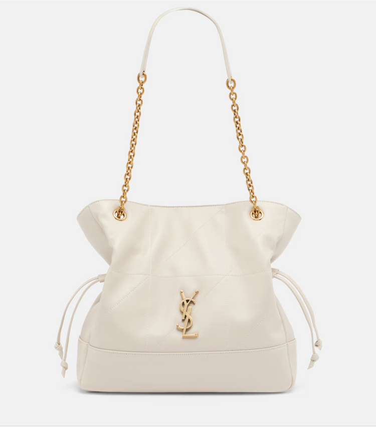 White handbag with gold chain strap and YSL logo on a light gray background