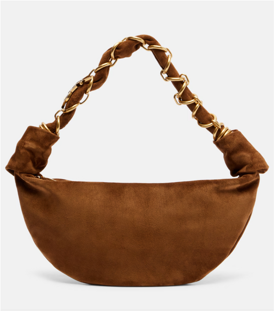 Brown suede handbag with gold chain handle on a light gray background