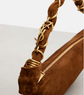 Brown handbag with gold braided handle on a white background