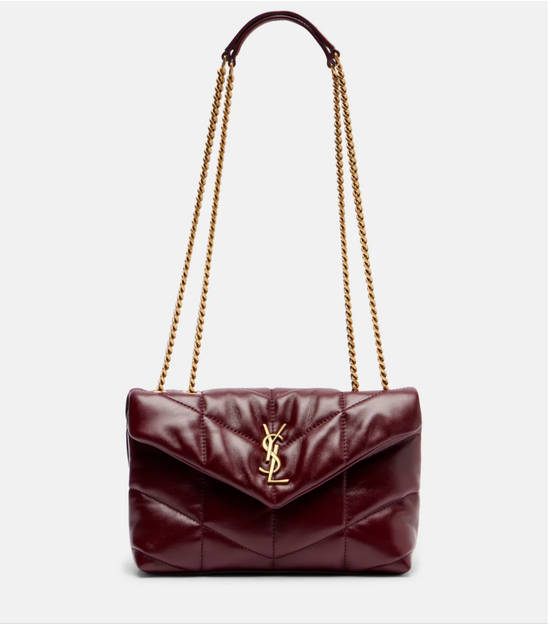 Burgundy handbag with gold chain strap on a white background