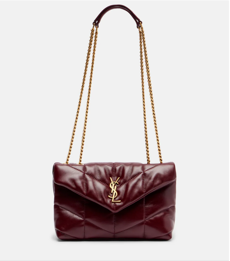 Burgundy handbag with gold chain strap on a white background